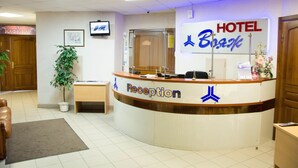 A hotel reception desk with a sign reading "HOTEL BIAK". - Voyage Hotel (Minsk)