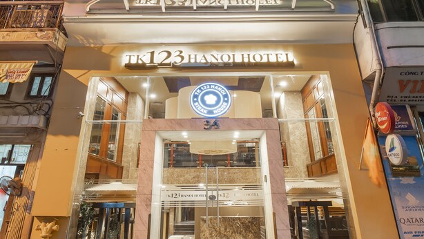 A hotel with a prominent entrance, multiple floors, and a sign indicating it is a hotel. - TK123 Hanoi Hotel (Hanoi)
