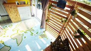 A room with a wooden desk, a laptop, and a window with curtains. - WH Hostel (Bangkok)