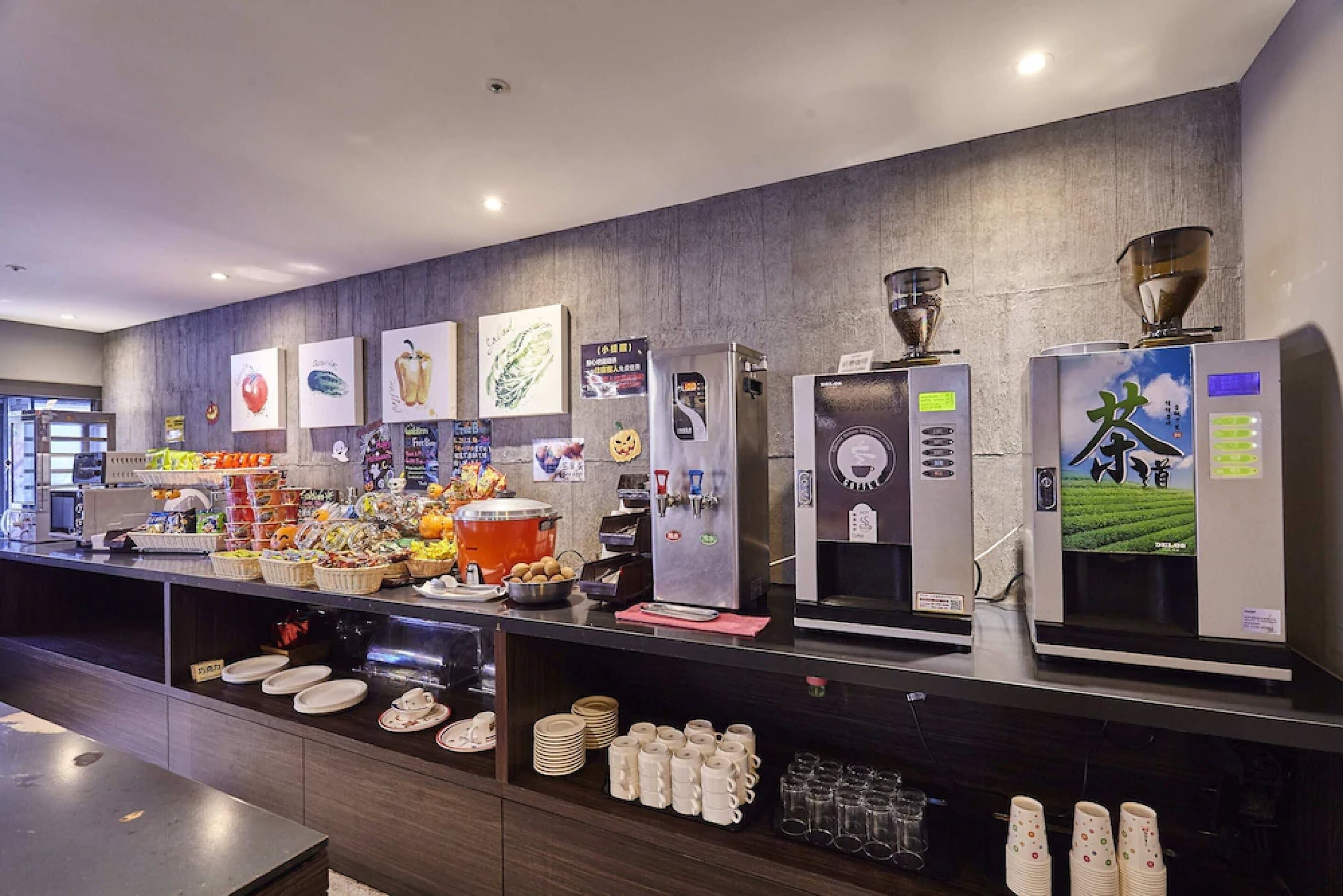 A buffet area with various food items, beverage dispensers, and a coffee machine.