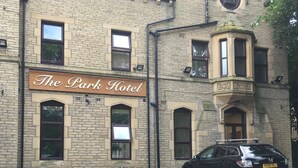 The Park Hotel with a parking area and a black car parked in front. - The Park Hotel (Bradford)
