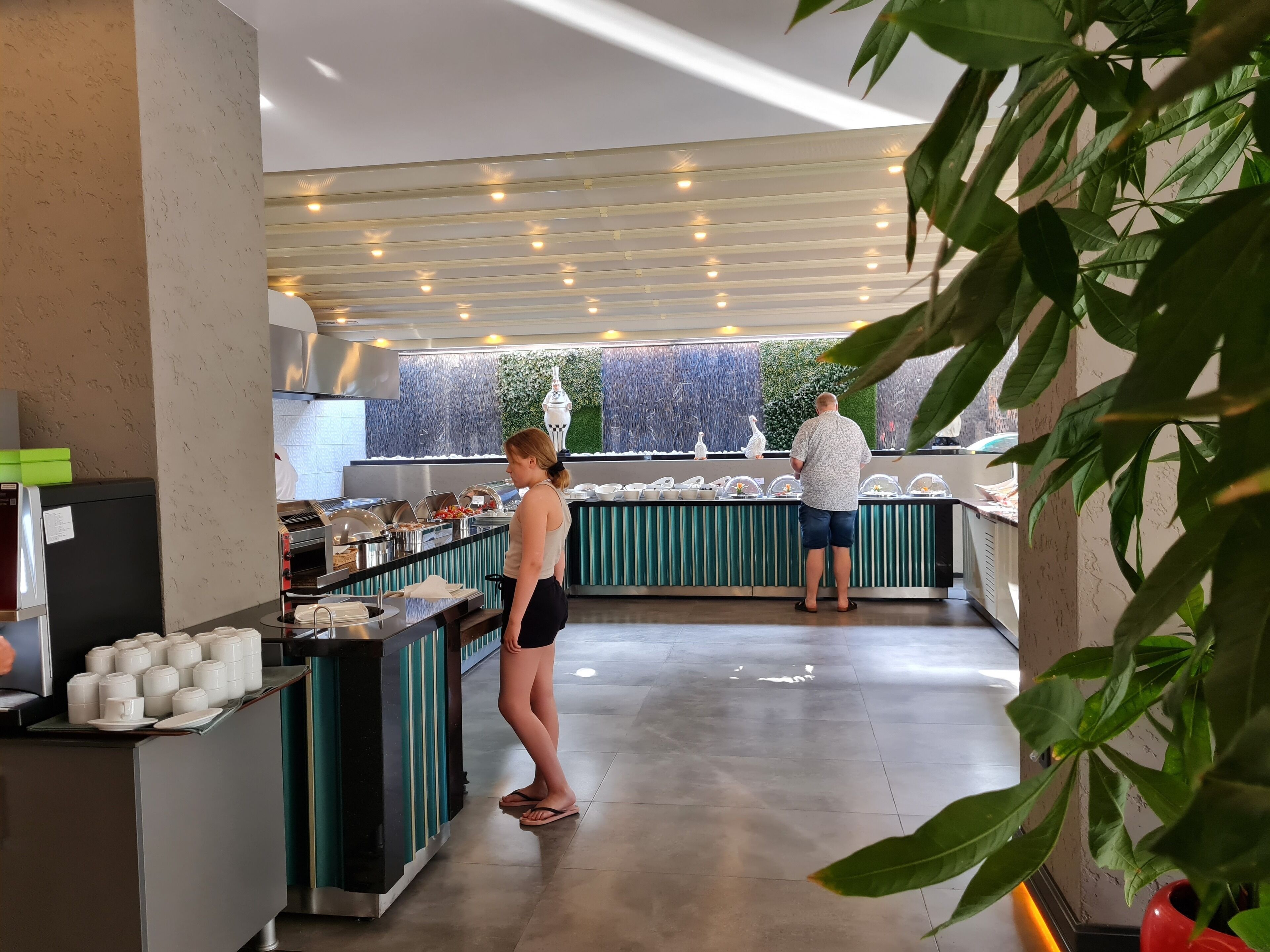 A buffet area with a variety of food items and a counter.