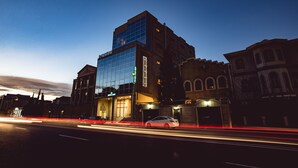 A modern building with a glass facade and a traditional brick structure. - Admiral Hotel Baku (Baku)