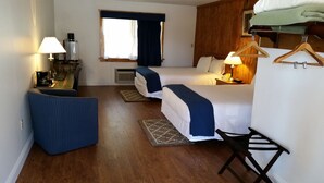 A hotel room with two beds, a desk with a lamp, a chair, a coffee machine, and a window with curtains. - Rhinebeck Village Inn (Rhinebeck)