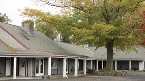 A two-story building with a covered porch and a stone chimney. - Rhinebeck Village Inn (Rhinebeck)