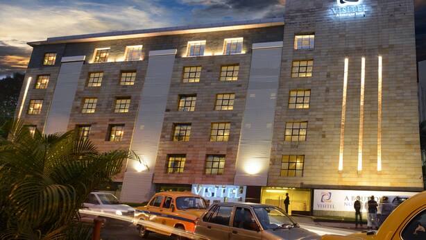 A hotel with a modern facade, multiple windows, and a prominent sign. - Visitel - A Boutique Hotel (Kolkata)
