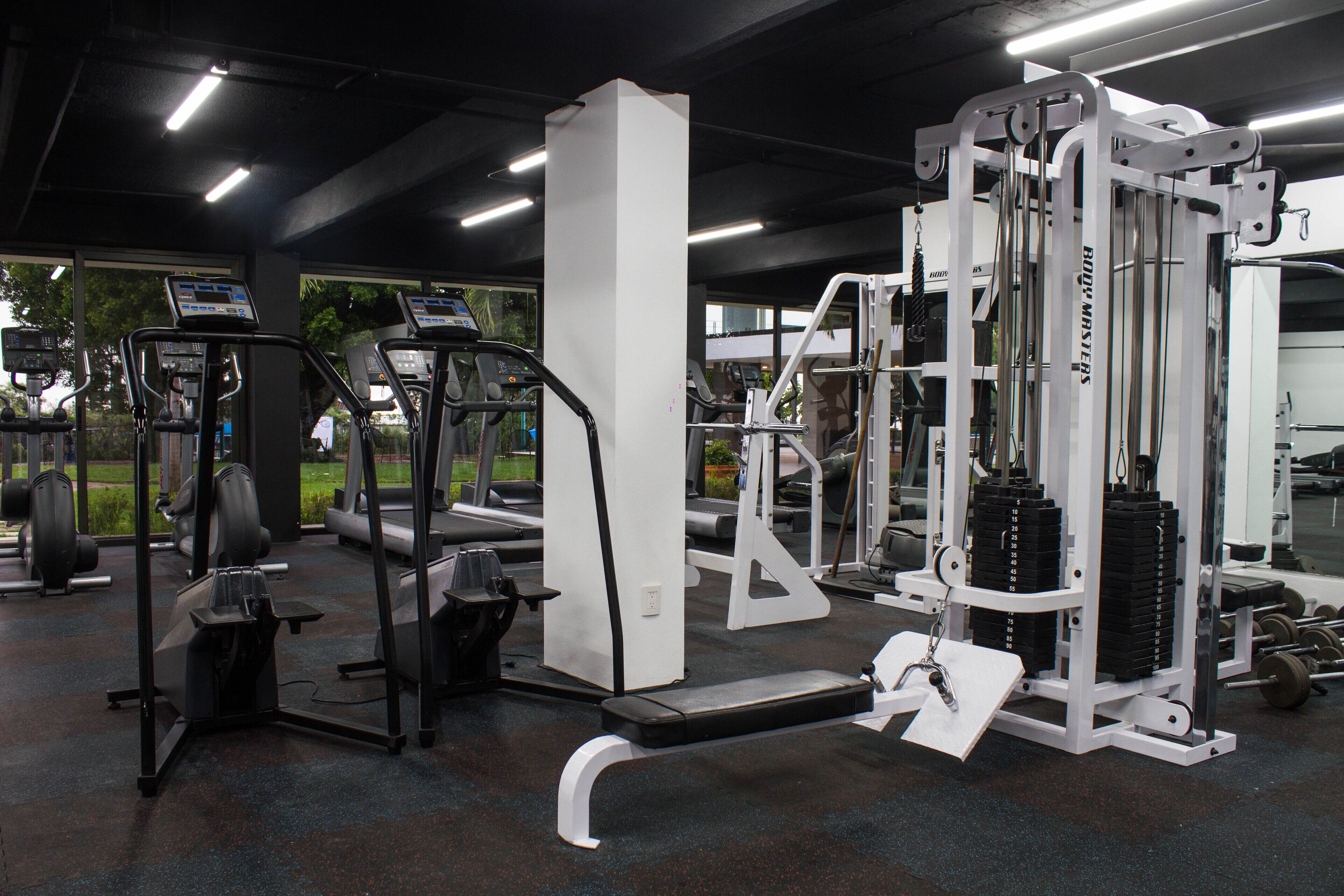 A gym with various exercise equipment, including treadmills and weight machines.