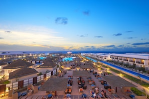 A resort with multiple pools, outdoor seating areas, and a view of the ocean. - Melia Llana Beach Resort & Spa - All Inclusive - Adults Only (Sal)