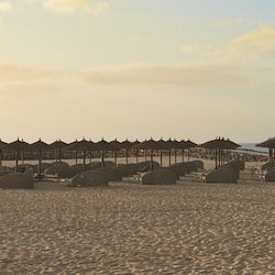 On the beach, sun-loungers, beach umbrellas, beach towels