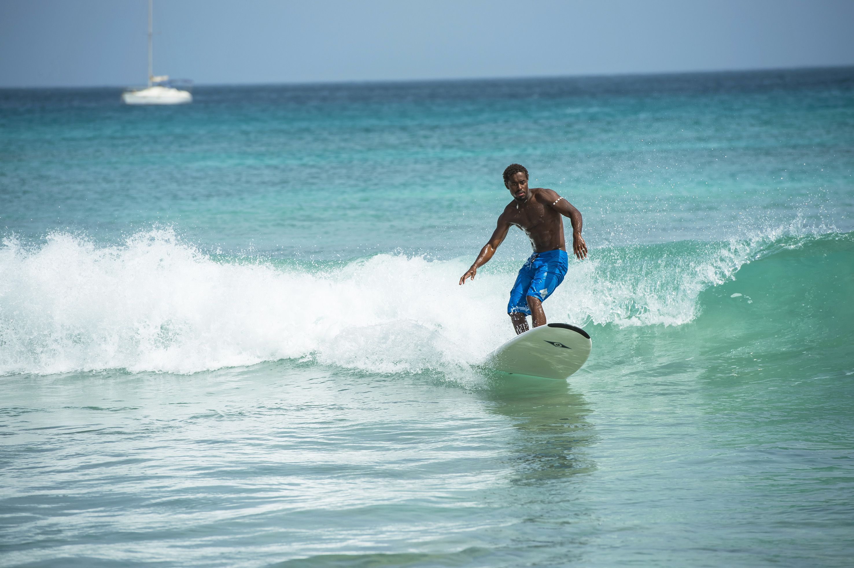 A person surfing on a wave in the ocean.