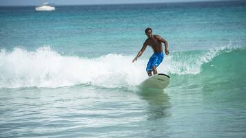 A person surfing on a wave in the ocean.