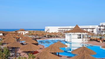 Relax by the pool surrounded by ocean views and shaded sun loungers.