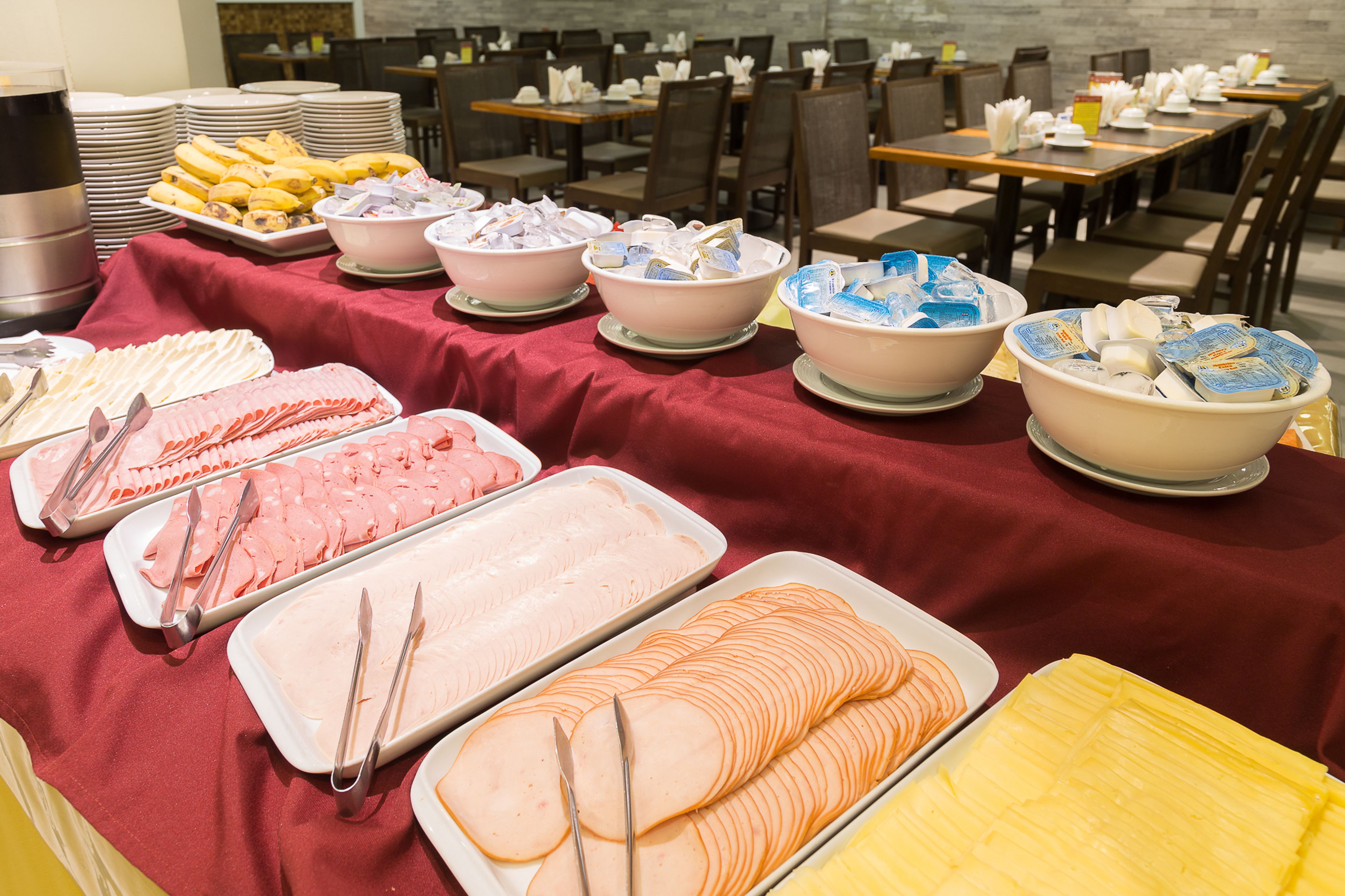 A buffet setup with various food items and utensils.