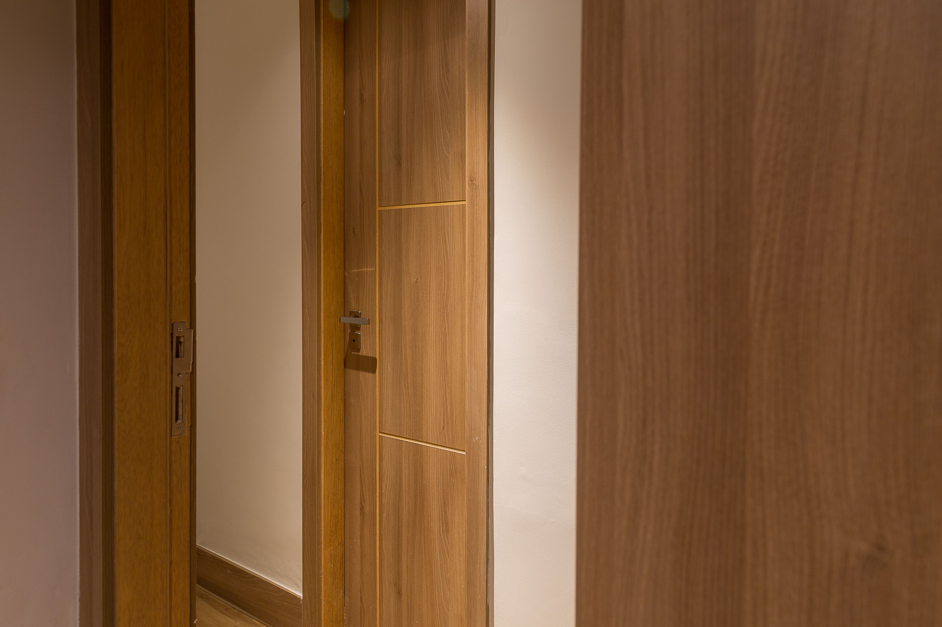 A wooden door with a simple handle and a small keyhole.