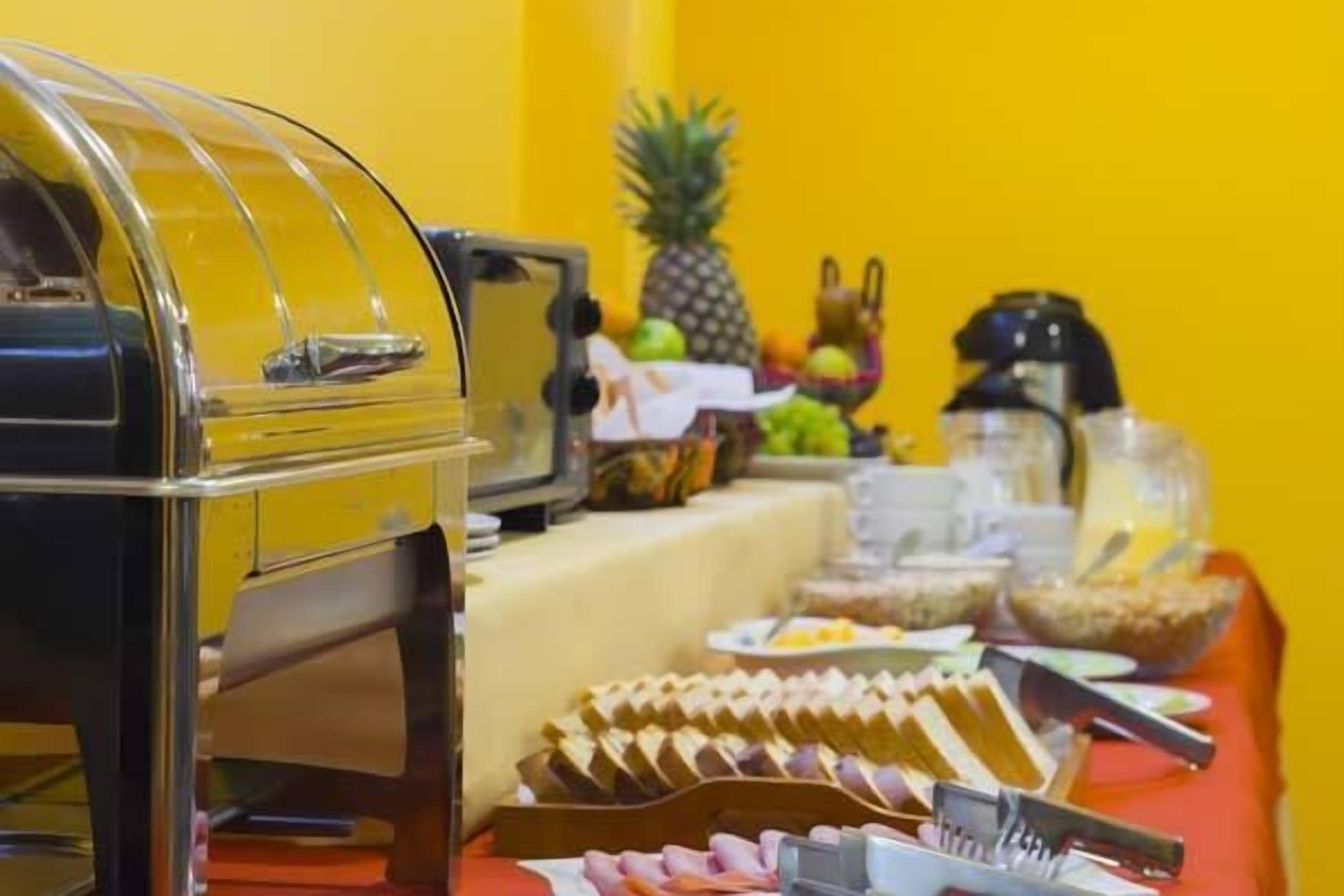 A buffet setup with various food items and a grill.