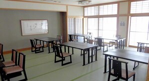 A classroom with multiple tables and chairs, large windows, and a whiteboard on the wall. - Tento No Sato Hotel Honjin Abashiriko (Abashiri)