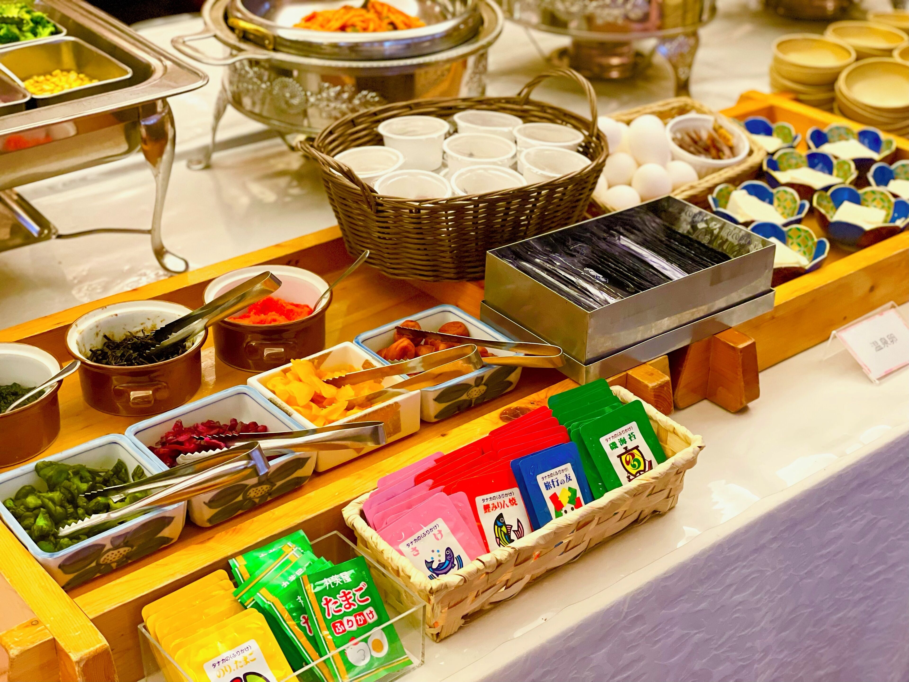 A buffet with various food items and condiments.