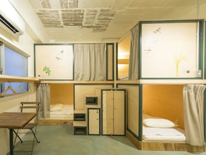 A compact room with a bunk bed, a small desk, and a wardrobe. - Guest House Denchi - Hostel (Tokyo)