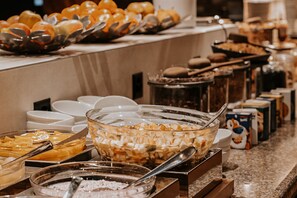 A buffet with various food items and utensils. - Victoria Hotel & Residence (Ollon)