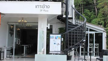 A modern building with a sign reading "SP Place" and a staircase leading to an upper level.
