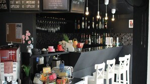 A bar area with a counter, seating, and various bar tools. - SP Place Hotel (Ko Chang)