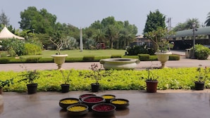 A garden with potted plants and flower arrangements. - UVA Meridian bay resort and spa (Kundapur)