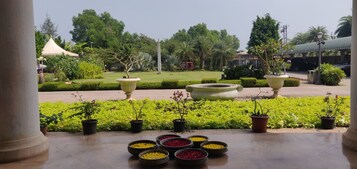 A garden with potted plants and flower arrangements.