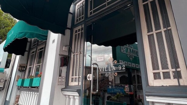 A building with a green awning, a sign reading "Villa 92", and a glass door entrance. - VILLA 92 - City Hotel - Hostel (Kandy)