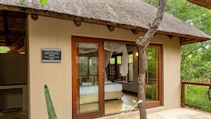 A room with a bed, a window, and a door. - Raptors Lodge (Hoedspruit)