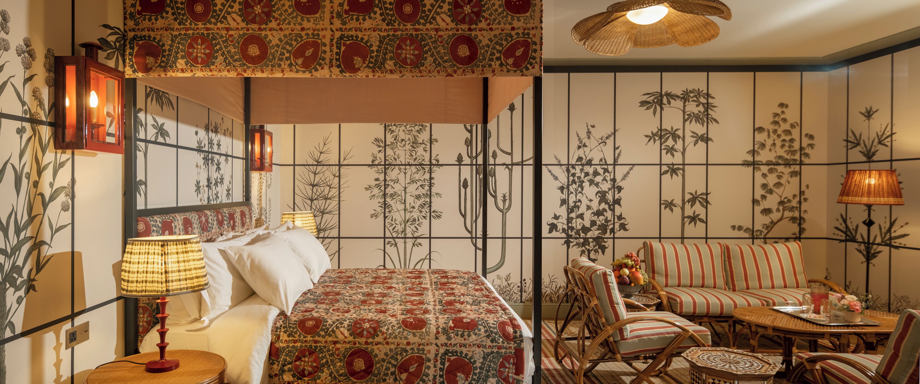A room with a bed, a sofa, and a dining table.