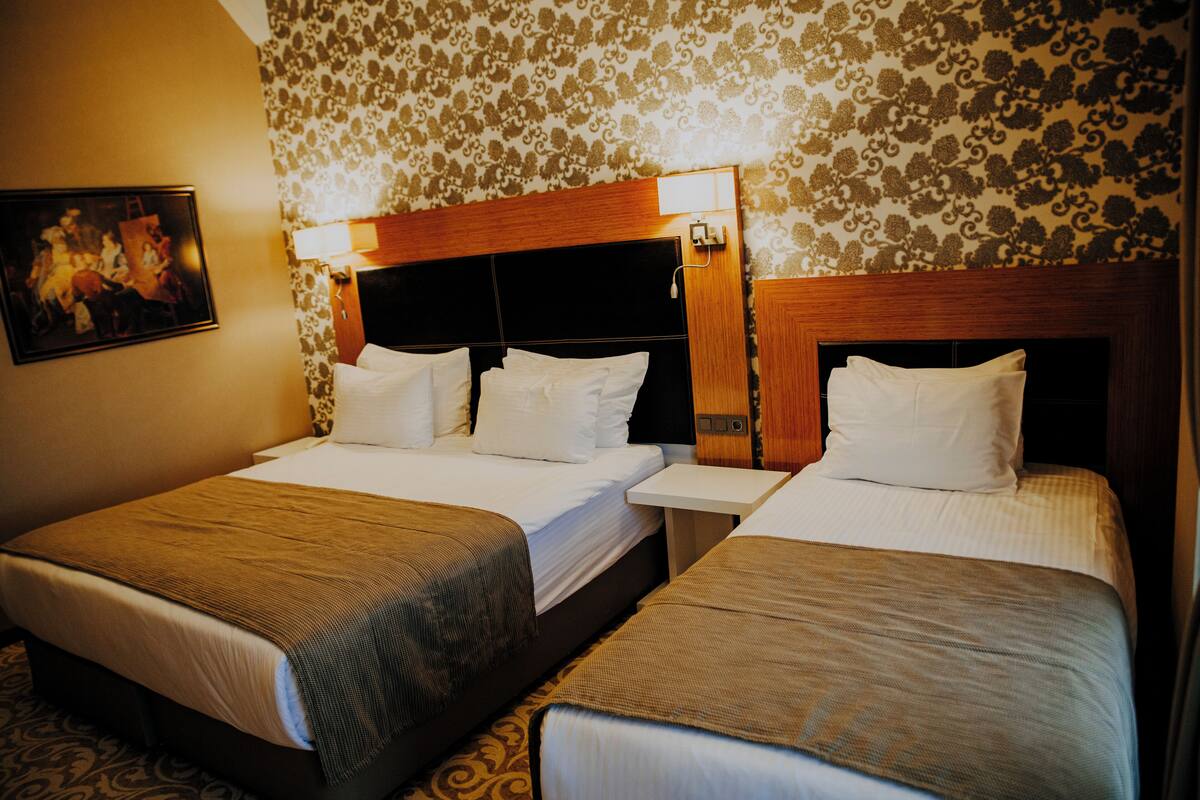 Deluxe Triple Room | Minibar, in-room safe, soundproofing, iron/ironing board (on request)