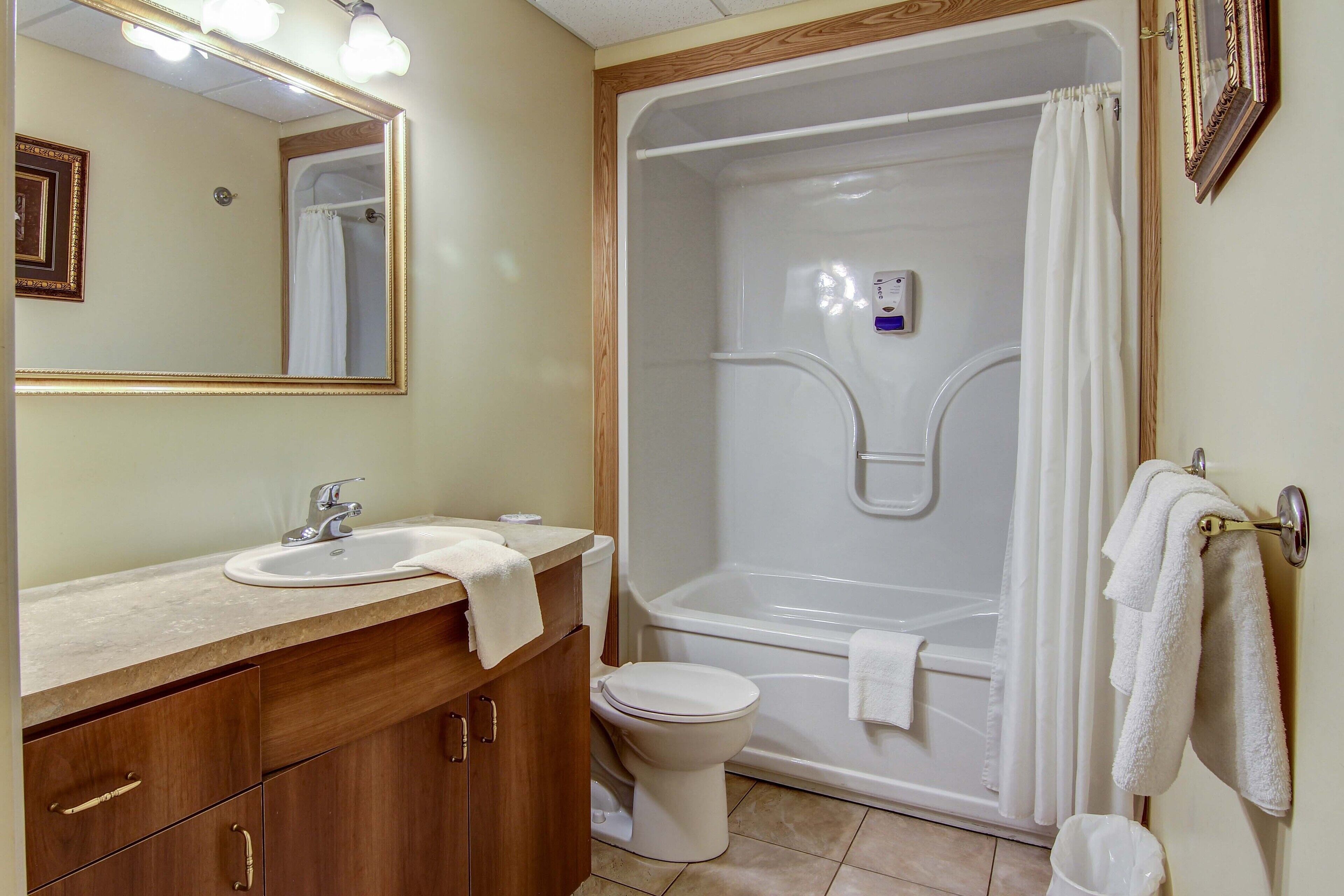 A bathroom with a sink, toilet, and bathtub.