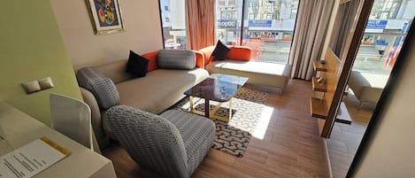 Deluxe Suite | Living area | 42-inch flat-screen TV with satellite channels, TV