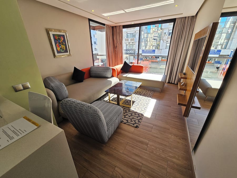 Deluxe Suite | Living area | 42-inch flat-screen TV with satellite channels, TV