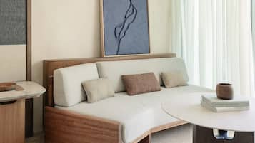 A modern room with a sofa, a table, and a wall art piece.