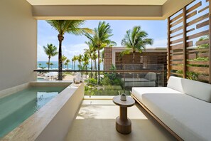 A balcony with a pool, a sofa, and a view of the beach and palm trees. - Alila Mayakoba by Hyatt (Playa del Carmen)