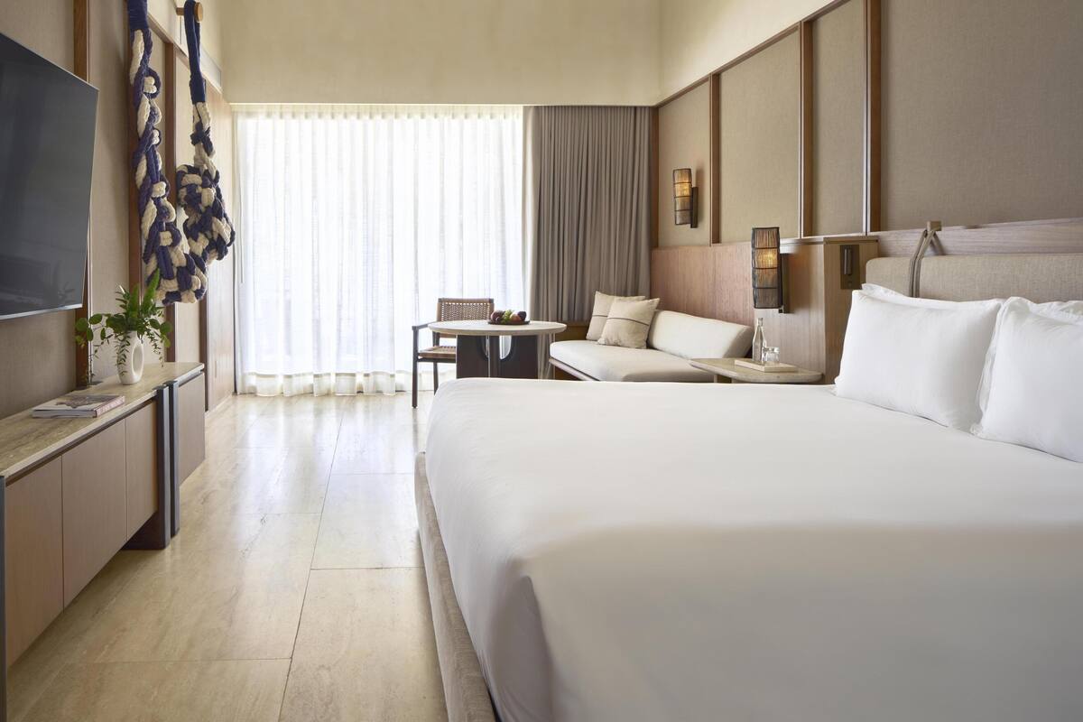 Premium bedding, free minibar items, in-room safe, laptop workspace