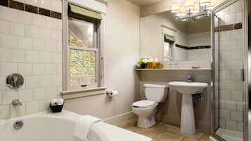 A bathroom with a bathtub, toilet, sink, and shower.