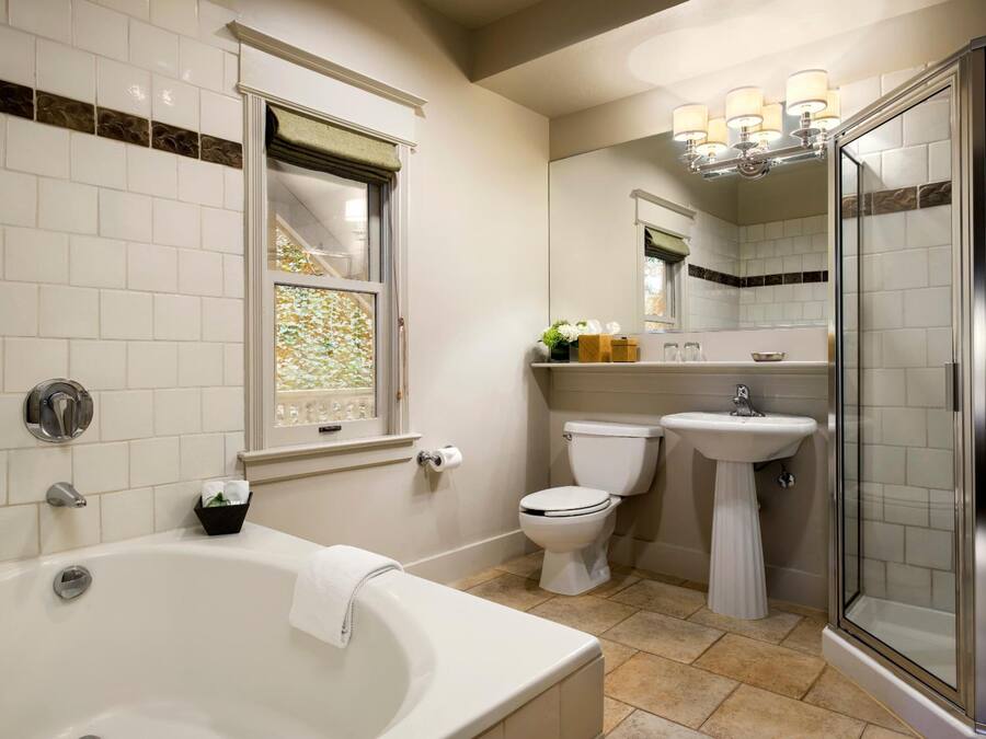 A bathroom with a bathtub, toilet, sink, and shower.