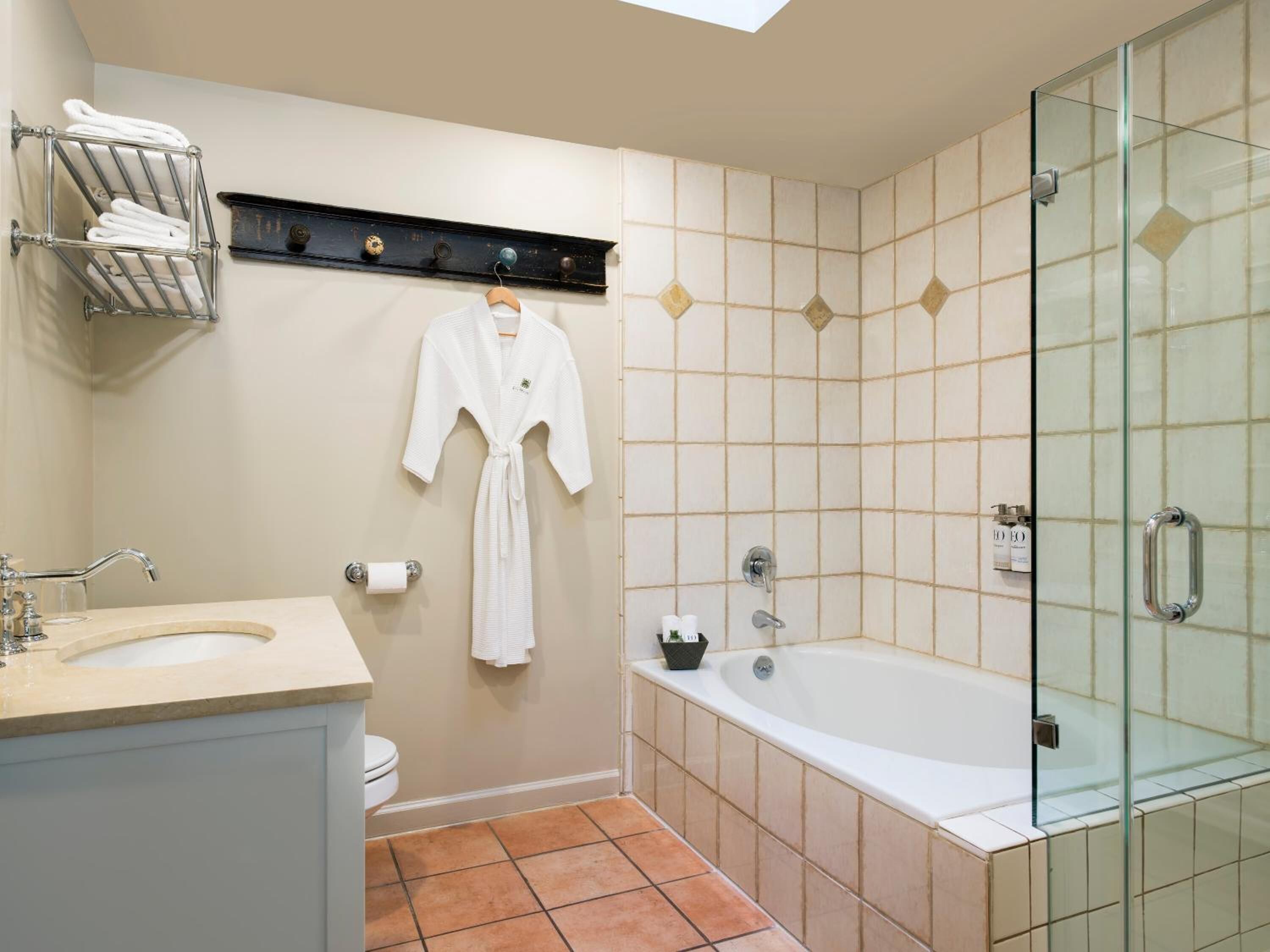 combined shower/bathtub, designer toiletries, hair dryer, bathrobes