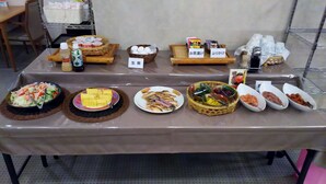 A buffet table with various dishes, including salads, fruits, and other food items. - Hotel Crown Hills Kitami (Kitami)