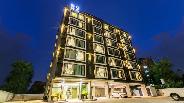 A multi-story hotel with a modern design, featuring a prominent 'B2' sign on the top.