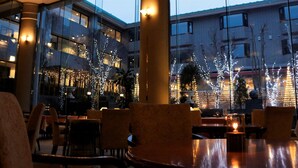 A restaurant with tables and chairs, large windows, and string lights. - Hotel Cypress Karuizawa (Karuizawa)