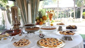 A buffet table with various desserts and fruits, including cakes, cookies, and a fruit bowl. - Hotel Borgo Antico (Ceprano)