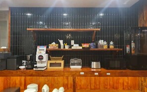 A counter with a coffee machine, a cash register, and various food items on display. - February Hotel - Busan Songdo (Busan)