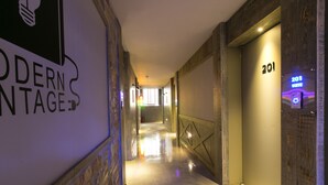 A modern hotel corridor with a sign reading "MODERN VINTAGE." - February Hotel Songdo Amnam (Busan)