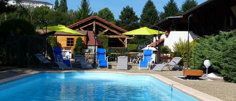 Seasonal outdoor pool, open 10:00 AM to 10:00 PM, pool umbrellas