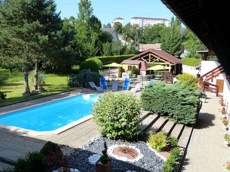 Seasonal outdoor pool, open 10:00 AM to 10:00 PM, pool umbrellas