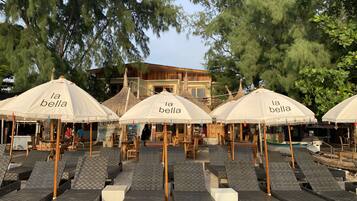 On the beach, white sand, sun-loungers, beach umbrellas