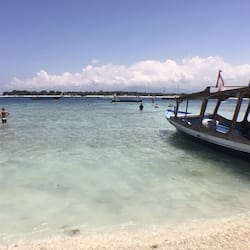 On the beach, white sand, sun loungers, beach umbrellas